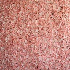 a large amount of pink and white sprinkles are on the wall next to a fire hydrant