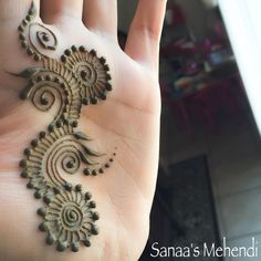 a person's hand with henna on it