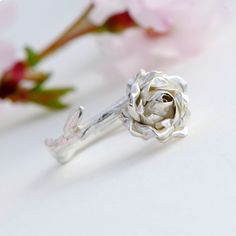 Engagement Ring, Sterling Silver Ring, Rose Flower Ring This makes a truly special gift for yourself or a loved one. Delicate silver rose ring handcrafted from sterling silver, the design features a beautiful open rose on a smooth rose stem. * Material: 925 Silver * Size of Rose: Approx. 1 cm (0.4 in) diameter and 0.5 cm (0.2 in) height * Ready to Ship in 2-3 business day * Made in the United Kingdom Every ring is individually handmade so that no two pieces are exactly the same. PACKAGING: Your Rose Design Flower Ring For Anniversary, Rose Gold Flower Design Promise Ring, Silver Flower Jewelry For Proposal, Elegant Silver Flower Ring For Valentine's Day, Silver Flower Promise Ring For Mother's Day, Rose Design Rings For Valentine's Day, Elegant Rose Flower Ring For Anniversary, Silver Flower Ring With Rose Design, Silver Flower Ring For Proposal