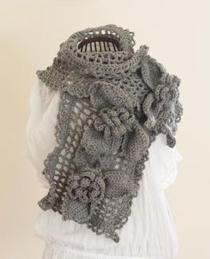 a gray crocheted scarf on top of a mannequin