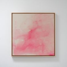 a pink painting hanging on the wall