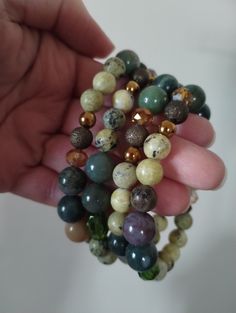 Beautiful Earthtone gemstone stretch bracelets..Made from multi colored 8 and 10mm green gemstone beads, glass, brass accent beads..Soo pretty alone or layered *7 inches in length *Sold separately *Choose from #1-4(all bracelets vary slightly but look very similar) *Made from genuine gemstone beads on durable stretch cord ✨ALL $35 ORDERS GET FREE SHIPPING ✨ PLEASE LEAVE A SHOP REVIEW AND TAG US ON INSTAGRAM AND FACEBOOK IF YOU LOVE YOUR NEW JEWELS STACK💚✨ LAYER 💚✨ LOVE Green Bohemian Stretch Bracelet With 8mm Beads, Bohemian Green Stretch Bracelet With 8mm Beads, Earthy Green Bracelets For Meditation, Earthy Green Beaded Bracelets With Gemstone Beads, Green Earthy Beaded Bracelet With Gemstone Beads, Green Round Beads Stretch Bracelet For Meditation, Spiritual Green Stretch Bracelet With Colorful Beads, Earthy Green Bracelets For Healing, Earthy Green Bracelet For Healing