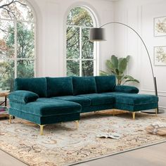 a living room scene with focus on the sectional sofa and large window in the background