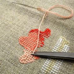 a pair of scissors sitting on top of a piece of fabric