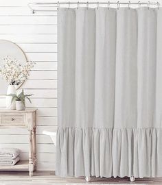 a white shower curtain with ruffles on it