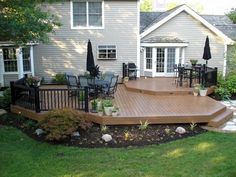 a wooden deck in front of a house