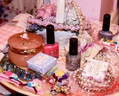 a table topped with lots of different types of nail polish and other things on top of it