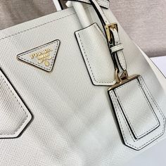 SHOP MORE LUXURY PRODUCTS HERE Description Prada Double Saffiano Mini Bag White For Women, Women’s Bags 9.8in/25cm 1BG443_2A4A_F0G3Z_V_XOO Sophisticated, subtle details bring new life to the brand’s iconic designs like the Prada Double bag with its new versatile and sophisticated mini design. Iconic metallic lettering adorns the front, while a removable shoulder strap allows the bag to be worn over the shoulder or as a crossbody bag. Size: 25 x 18.5 x 12.5 cm /9.8 x 7.3 x 4.9 inches Prada Double Bag, Metal Lettering, Prada Re Edition, Louis Vuitton Shirt, Embroidered Handbag, Fabric Handbags, Prada Saffiano, Prada Bags, Luxury Products