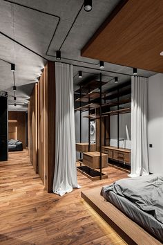 a bedroom with wooden floors and white drapes