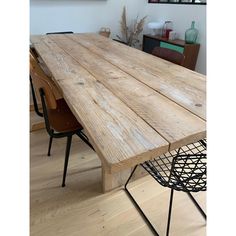 a large wooden table sitting on top of a hard wood floor