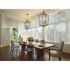 a dining room table with chairs and chandelier