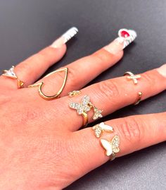 The Lorrie Rings - y2k gold adjustable wire butterfly and heart rings. A set of 5 trendy chic rings. 💕 Visit my shop for more listings xoxo https://www.etsy.com/shop/JennissiJewelry Trendy White Crystal Promise Ring, Trendy White Crystal Open Ring, Trendy White Midi Rings For Gifts, White Trendy Midi Rings As Gift, Trendy White Midi Promise Rings, Y2k White Jewelry For Gift, Y2k White Jewelry Gift, Y2k Style White Jewelry For Gift, Rings Y2k