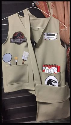 the back of a man's jacket with patches and pins on it, hanging from a clothes line