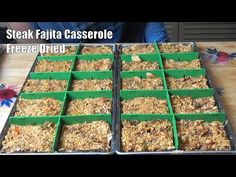 two trays filled with granola sitting on top of a wooden table next to each other