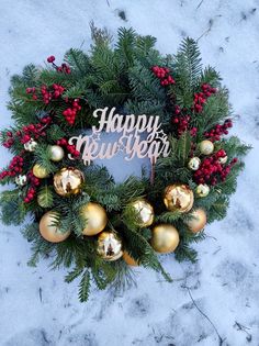 a christmas wreath with the words happy new year on it