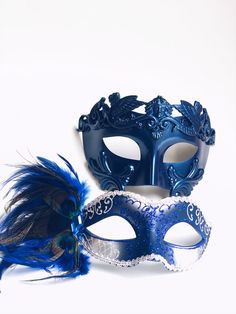 This Venetian Blue Mask Pair is the ultimate duo for elegant masquerade events. The women’s mask features intricate silver filigree and blue glitter accents, complemented by peacock feathers for a dramatic flair. The men’s mask offers a regal blue crown design, making it a statement piece for formal events and masquerade balls. Perfect for couples looking to match their style and sophistication. Age Group/Gender - Adult/Unisex Size/Type - One size fits all adults Mask Colors - Blue/gold/black Ma Elegant Blue Masquerade Mask For Parties, Blue Venetian Masquerade Mask For Party, Blue Masquerade Mask For Carnival Costume Party, Blue Venetian Mask For Carnival, Blue Venetian Masks For Carnival, Blue Masquerade Mask For Mardi Gras Costume Party, Elegant Blue Mask For Masquerade, Blue Masks For Carnival Costume Party, Blue Masks And Prosthetics For Carnival Costume Party