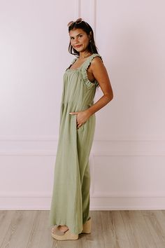 - This flowy jumpsuit is an instant style upgrade! - Unlined material - A ruffled, square cut, elastic neckline - A sleeveless cut featuring 2-inch elastic straps - Functional side pockets - A relaxed jumpsuit silhouette that ends in wide floor length hemlines Measurements S : Bust 36", Hip 44", Inseam 27.5", Length 56", Torso 23", Waist 36". M : Bust 38", Hip 46", Inseam 27.5", Length 56", Torso 23.5", Waist 38". L : Bust 40", Hip 48", Inseam 28", Length 56.5", Torso 24", Waist 40". Green Smocked Back Jumpsuit For Summer, Spring Jumpsuits And Rompers With Ruffled Straps, Green Sleeveless Ruffled Jumpsuits And Rompers, Green Smocked Back Jumpsuits For Spring, Flowy Jumpsuit, Style Upgrade, Square Cut, Linen Blend, Floor Length