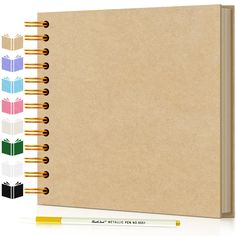 an open notebook with colored pencils next to it and the cover is lined in brown paper