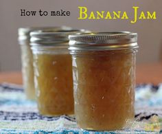 two jars filled with banana jam sitting on top of a blue and white table cloth