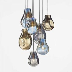 a bunch of light bulbs that are hanging from the ceiling in different shapes and sizes