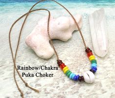 "🌺 Item Details ♥ Size/length: Fits up to 19\" length - Adjustable ♥ Details: Beautiful rainbow/chakra Puka shell suspended from a hand-braided faux sinew necklace. Rainbow beads are glass trade beads This is 18\" long, but you can shorten it by tying new knots and cutting off excess if you want a choker. Be sure to leave 1/2 inch of string at the end of the knot. Very simple, eye-catching and lovely. Perfect to wear every day to remind you of the beach, ocean, or tropical trip. Makes a lovely Sinew Necklace, Simple Eye, Shell Choker, Surfer Necklace, Puka Shell, Unisex Necklace, Rainbow Beads, Trade Beads, Beautiful Rainbow