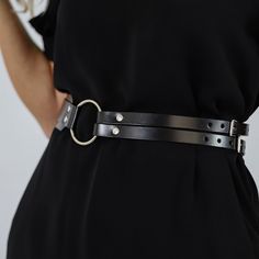 With a modern design, this leather belt is the ideal pick for those who want to complete their outfit. Wear it over a shirt or a dress and be in the spotlight. Handcrafted in EU using Italian Full Grain Leather and Nickel Plated Hardware        It is recommended to clean the products after each wear as follows:  The leather parts should be wiped with a soft cloth, slightly damp, and let dry at room temperature the metallic elements should be well wiped with a dry cloth  It is NOT recommended to Luxury Modern Belts With Logo Strap, Waist Belt Outfit, Waist Harness, Cincher Belt, Wide Belts For Women, Harness Belt, Wide Leather Belt, Leather Harness, Waist Cincher