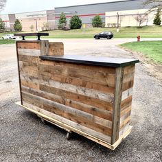 a wooden bar sitting on top of a trailer