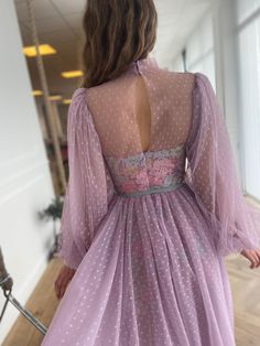 Details: -Dotted tulle and lace fabric -Purple essence color -Corset with strapless bra -Draped blouse with a turtleneck collar shape over the corset -Tea length style with side pockets -Long puffy sleeves - Aqua turquoise bow belt