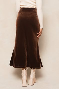 Embrace a playful and maternity-friendly look with our Logan Skirt in Brown. Made with soft velvet fabric, this midi-length skirt features an elastic waistband, hidden side zipper, and fabric with stretch for a comfy fit. Finish off the perfect fall outfit with one of our beautiful blouses. Cheap Pleated Fall Bottoms, Long Fall Skirts, Suede Midi Skirt Outfit, Satin Skirt With Boots, Pleated Skirt And Boots, Brown Pleated Skirt Outfit, Thanks Giving Outfits Women, Fall Church Outfit, Fall Maxi Skirt Outfits