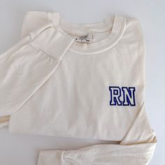 My absolute favorite tee! This long sleeve 'RN' tee can be customized to your preferred thread color and is stitched on a Comfort Colors long sleeve unisex tee.  Please wash on gentle cycle and dry on low.  If you are wanting a different design, wording, or a different clothing style, please send me a message so we can discuss the details. Please include thread color at checkout *Please note this listing is for the phrase 'MAMA' only. IF interested in different text/more characters, please send me a message. Long Sleeve Cotton T-shirt For Loungewear, Long Sleeve T-shirt With Embroidered Graphics For Fall, Cotton Long Sleeve T-shirt For Loungewear, Long Sleeve Cotton Top With Screen Print, Relaxed Fit Embroidered Tops For Loungewear, Long Sleeve Graphic Print T-shirt For Loungewear, Long Sleeve Cotton Tops With Letter Print, Casual Embroidered T-shirt For Loungewear, Casual Embroidered Loungewear T-shirt