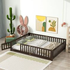 a baby crib in the middle of a room with cactus decorations on the wall