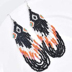 Approx 5" Handcrafted Bohemian Tassel Fringe Dangle Earrings Multicolored In Black Orange And White Boho Statement Jewelry Most Of My Other Earrings Are Dangle Types (Like These) That Can Be Upgraded To Solid Sterling Silver Or 14k Gold Filled Wires. I Have Some Extra Stainless Steel Wires And Gold Tone Wires Too. If You Want To Switch Out The Wires To One Of Those I Will Customize Them For You For Free. I Have A Background In Jewelry Design In Nyc And I Buy My Ear Wires From A Legitimate Metal Black Bohemian Tassel Earrings With Round Beads, Bohemian Black Tassel Earrings With Round Beads, Orange Beaded Earrings With Black Beads, Orange Dangle Earrings With Black Beads, Black Beaded Earrings With Tassels, Black Beaded Earrings With Dangling Beads For Beach, Black Beaded Fringe Tassel Earrings For Festival, Orange Dangle Beaded Earrings With Black Beads, Orange And Black Beads Dangle Earrings