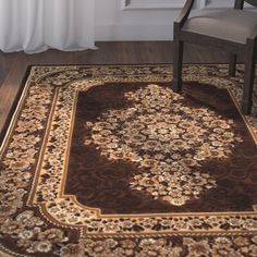 a brown and gold rug in front of a window