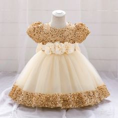 Be the star of the party with our Big Bow Gold Sequins Party Dress! This glitzy and elegant dress features a stunning gold sequin design with a playful bow and delicate lace tutu. Perfect for first birthdays, weddings, proms, or Christmas events. Crown your little princess with this dress and watch her shine! Material: Girls First Communion Dresses, Birthday Princess Dress, Girls Baptism Dress, 1st Birthday Dresses, Toddler Tutu, Baptism Dress, Birthday Princess, Christening Dress, Sequin Party Dress