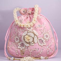 Material:Silk, Golden Tread, Golden Sequins, MotifsColor: Pink, Orange, Yellow, BluePackage Contents: As per quantity purchasedDesigned with the heart, this beautiful Potli or batawa bag are eye catchy and made of premium material.Key Features:Embroidery art work.This potli is good match with both Indian and western outfits and are superb for wedding and festive parties.This would be best complement to your designer saree, lenhga or any other kind of dress.This is the combination of traditional Embellished Clutch Potli Bag, Traditional Embellished Pouch Bag, Traditional Pink Shoulder Bag For Evening, Festive Embellished Pouch Shoulder Bag, Pink Bags For Evening And Festivals, Elegant Pearl Embroidered Fabric For Celebration, Festive Pink Potli Bag For Party, Pink Shoulder Bag With Handwork For Party, Festive Beaded Handheld Bags