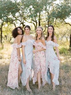 three bridesmaids posing for a photo in the woods