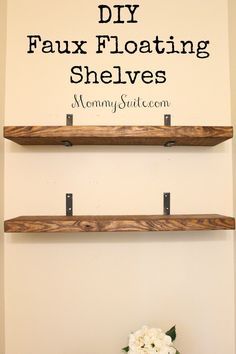 two wooden shelves with flowers on top and the words diy faux floating shelves above them