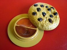 a cookie sitting on top of a yellow plate next to an orange and red sauce