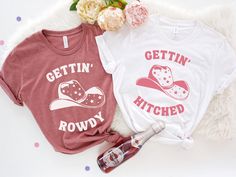 "This Gettin' Hitched and Gettin' Rowdy shirt, is perfect for each party goer at the Bachelorette party. This shirt will be perfect for any Western themed Bachelorette party or just some fun time in the city . ♥ HOW TO ORDER ♥ 1. Select the \"Shirt Style + Size\" (see images for options). 2. Select the \"Shirt Color\" 3. Enter custom text under Personalization.  4. Add to cart and checkout  S I Z I N G   &   C O L O R S - Please refer to sizing and color charts in the images U N I S E X    T S H I R T  P R O D U C T   D E T A I L S - Printed with ink - Unisex Tshirt - The collar is ribbed knit, so it retains its shape even after washing. - Loose fit for a comfortable feel F A B R I C A T I O N  - Solid colors are 100% cotton except Ash - 99% cotton and 1% polyester,  - Heather colors are 5 Hen Party Short Sleeve T-shirt With Letter Print, Summer Hen Party T-shirt With Graphic Print, Short Sleeve T-shirt For Hen Party With Letter Print, Fitted Short Sleeve T-shirt For Hen Party, Fitted Short Sleeve Tops For Hen Party, Fitted Letter Print T-shirt For Hen Party, Graphic Print Crew Neck Top For Hen Party, Cotton Short Sleeve Tops For Hen Party, Pink Hen Party Top With Graphic Print