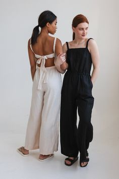 "Chic linen jumpsuit with eye-catching open back details. Comfy yet worthy of any occasion. Offered in medium-weight linen. STYLE DETAILS * Regular fit * Square neckline * Slightly ruffled elastic straps * Elastic waistline * Ties at the back * Full length * Pockets in side seams * Made from medium-weight linen SIZES & COLORS IN THE PICTURES * Model 1 is wearing size S/M in Buttercream (medium) linen. Model's height - 175 cm (5'9\"), bust - 80 cm (31.5\"), waist - 60 cm (23.6\"), hips - 92 cm (3 Loose Linen Overalls, Chic Linen Jumpsuits And Rompers For Summer, Spring Backless Jumpsuits And Rompers For Loungewear, Chic Wide Leg Jumpsuits And Rompers With Tie Back, Summer Wide-leg Relaxed Fit Jumpsuits And Rompers, Summer Wide Leg Jumpsuits And Rompers With Relaxed Fit, Casual Loungewear Jumpsuits And Rompers With Tie Back, Casual Jumpsuits And Rompers With Tie Back For Loungewear, Chic Linen Jumpsuits And Rompers With Pockets