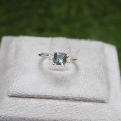 * Material: 925 Sterling Silver * DETAILS ✥ Handmade Ring ✥ - Center Stone: Mystic Topaz  - Center Stone Size: 6 MM - Center Stone Shape: Cushion  - Side Stone: CZ Diamond - Band Color: Silver Shiny ✥ O T H E R ∙ I N F O R M A T I ON ✥ ♦ Your item will be nicely packed to gift in elegant jewelry boxes. ♦ Custom Order We can make custom rings in almost any shape and style. If you want a specific model, please send us a clear picture and we will do our best. ♦ Delivery All Item will be Shipped wit Birthstone Engagement Rings, Mystic Topaz Ring, Topaz Engagement Ring, November Birthstone, Mystic Topaz, Ring Promise, Anniversary Gift For Her, Cz Diamond, Diamond Band