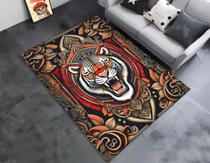 a living room area rug with a tiger design on the floor and a couch in the background