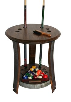 a wooden table topped with lots of pool balls and cues on top of it