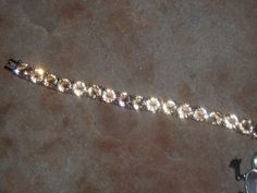 "Beautiful Green 127.00 Carats of AAA Rare Champagne Topaz 6mm Gemstones, 18K White Gold 7 1/2\" Inch Tennis Bracelet. FREE SHIPPING in the USA, $11 Everywhere else, it costs me $14.83 to ship to other countries, so I have to recover some of this cost champagne Topaz mailing. **Matching Earrings in Earring Section. ** Matching Necklaces in Drops Section. **Full Money Back Guaranteed to be Real Gemstones These are Real Gemstones from the \"Top Crust\" of the mine, they have not been under pressur Elegant Formal Topaz Bracelets, Formal Gold Bracelet With Sparkling Stones, Sparkling Gold Tennis Bracelet For Anniversary, Gold Diamond Bracelet With Sparkling Detail For Anniversary, Gold Sparkling Diamond Bracelet For Anniversary, Formal Crystal Bracelet With Stones, Sparkling Gold Bracelets For Formal Occasions, Gold Sparkling Crystal Bracelet For Anniversary, Gold Sparkling Diamond Bracelet For Formal Occasions