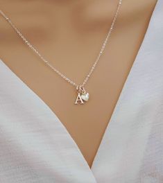 💖 Imagine the moment when you reveal this stunning initial & heart necklace... So pretty and absolutely gorgeous, she's sure to fall in love upon first glance!   💖 The most beautiful gift for yourself or someone special. Such a classy and elegant necklace she is sure to treasure forever. Delight her today with a precious and personalised gift.  Why Choose Our Initial & Heart Necklace? ✨ Elevate your style effortlessly ✨ A heartfelt gift that shows her how special she is ✨ Premium Quality Sterl Dainty Initial Pendant Charm Necklace For Mother's Day, Dainty Mother's Day Charm Necklace With Initial Pendant, Dainty Mother's Day Initial Pendant Charm Necklace, Initial Pendant Charm Necklace As Gift For Her, Dainty Initial Pendant Charm Necklace For Mom, Anniversary Charm Necklace With Initial Pendant, Silver Heart Initial Necklace For Valentine's Day, Silver Heart Initial Necklace For Mother's Day, Silver Initial Pendant Necklace With Heart Charm