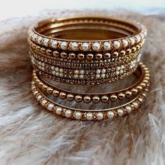 Choora - Bangles Jewellery - Karwachauth - Navrati - Bollywood -Weddings - Eid - Diwali Parties - Ladies sangeet Sizes - 2.4/2.6/2.8/2.10 Colours - Orange, Yellow, Light blue, Beige, Turquoise, Red, Light pink, Pink  2.4 is 2.25 inches 2.6 is 2.37 inches 2.8 is 2.5 inches 2.10 is 2.62 inches Other designs available please check my other listings! Material - Stunning gold colour bangles with pearl setting  Set is for one hand only . 7 bangles per pack  We can mix and match your preferred colours Pearl Setting, Ladies Sangeet, Pakistani Jewellery, Diwali Party, Bollywood Wedding, Pakistani Jewelry, Photography Lighting, Ring Ideas, Wedding Band Sets