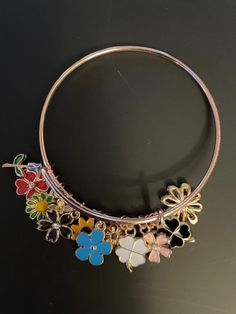 One adjustable handmade bracelet/bangle with floral charms / approx. 12 charms. CHARMS-rose gold/gold/silver flowers and clovers. Makes a great all-around gift, birthday gift, holiday gift or for self. Please visit my shop at https://www.etsy.com/shop/lilnjayproducts for more beautiful items. Bracelet Clover, Clover Charm, Beautiful Items, Charm Bangle, Bracelet Bangle, Handmade Bracelet, Flower Charm, Silver Flowers, Gold Gold