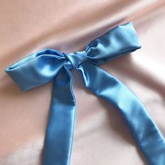 "Our new multiuse silk tie is designed to allow you to wear it in multiple ways; tie the silk scarf in a bow around ponytails or buns, thread your silk tie through a braid, wrap it around your head as a hair band or even wear it as a short tie around your neck. Approximately 3cm or 1 1/8\" wide and 95cm or 37 3/4\" long. 94% Silk, 6% Spandex, 19 momme. We use a silk spandex mix because it has a better handle and a little extra stretch which makes a more durable fabric. We recommend a gentle hand Elegant Blue Satin Silk Scarf, Summer Party Satin Silk Scarf, Head Scarf Tying, Scarf Tie, Hair Ribbon, Silk Hair, Scarf Tying, Blue Silk, Silk Ties