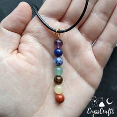 This natural Chakra stone drop pendant necklace is perfect for balancing and recharging your chakras. This necklace features 7 natural stones to represent each chakra (amethyst, lapis lazuli, sodalite, green aventurine, tigers eye, yellow Jade, and red Jasper) Pendant is hung on wax coated thread with a lobster claw clasp closure. Multicolor Spiritual Charm Necklaces For Gift, Gemstone Pendant Charm Necklace For Meditation, Spiritual Wire Wrapped Multicolor Crystal Necklaces, Rainbow Round Beads Necklace For Healing, Spiritual Multicolor Wire-wrapped Crystal Necklaces, Spiritual Multicolor Wire Wrapped Crystal Necklaces, Dangle Gemstone Jewelry For Meditation, Holistic Multicolor Gemstone Beads Jewelry, Healing Natural Stones Round Pendant Charm Necklace