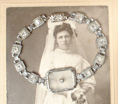 "Offering an beyond stunning, antique 1920s - 1930s era Art Deco/Edwardian camphor glass silver rhodium plated filigree and French paste rhinestone link bracelet.  The perfect \"Something Old\" for the Bride and with a pair of jeans afterwards!  I have always been a huge fan of camphor glass and this is one is unusual and gorgeous. The SO Art Deco/Edwardian designed ornate bracelet measures 7 1/2 inches (19.1 cm) long and is just under 3/4 inch at 11/16 inches (17mm) wide at the centerpiece. The bracelet features a large ornate rhodium plated embossed centerpiece set with camphor glass that has the classic radial starburst designs cut in the glass on the reverse side. The center is adorned with a sparkly crystal rhinestone.  Extending out from the centerpiece on either side are geometric s Camphor Glass Jewelry, Wedding Something Old, Rhinestone Bridal Jewelry, Vintage Rhinestone Jewelry, 1920s Wedding, Wedding Jewelry Bracelets, Rhinestone Bridal, Glass Bracelet, Bracelet Vintage